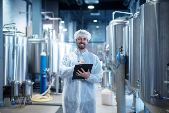 a man in a white robe holding a clipboard